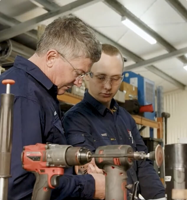 engineer-finishing-bronze-gear-wheel-in-engineerin-2024-10-21-00-35-13-utc